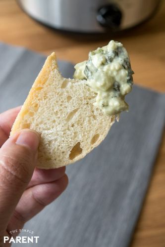 piece of bread with crockpot spinach dip