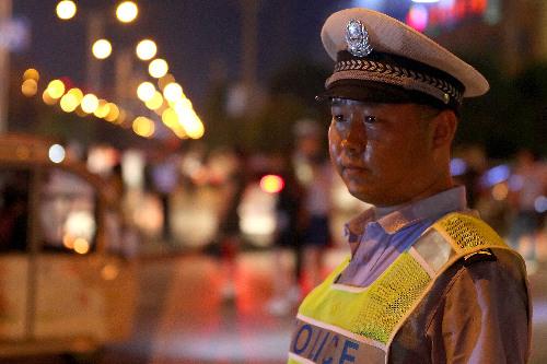 图为交警在新蔡县月亮湾公园入口处执勤.