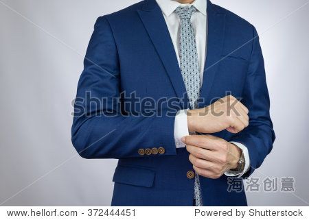 businessman fitting up blue suit and grey necktie