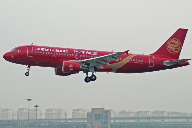 吉祥航空首架整机彩绘飞机,机身喷涂酒红色,镶嵌金色流线型飘带,机尾