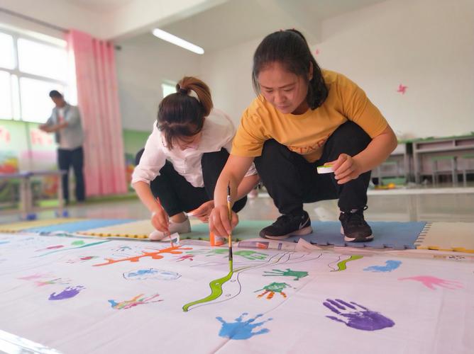 就让图片带你走进老师和幼儿集体"手脚并画"的创作活动现场吧