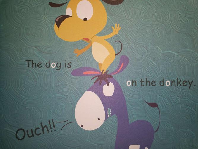 the dog is on the donkey. ouch!