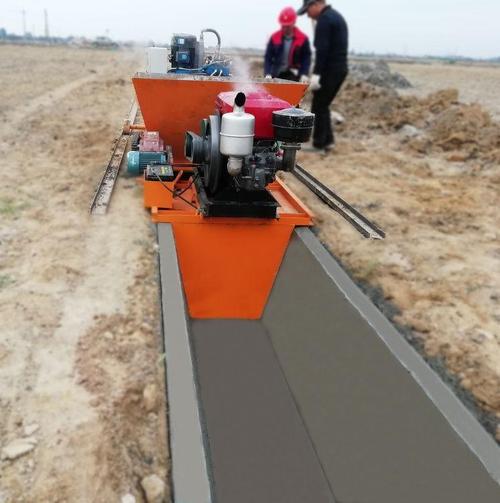 本厂生产的u型梯形水渠边沟全自动一次性现浇成型机广泛应用于农田