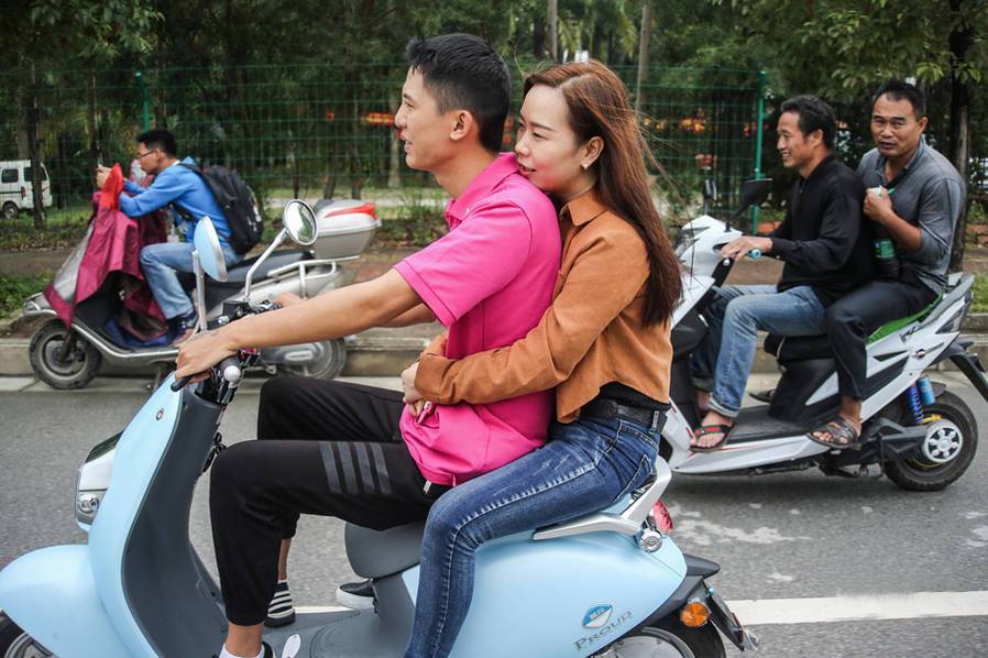 每天,韦勇都会骑上电动车载着小梁上班,一路上小梁紧紧抱着韦勇的腰.