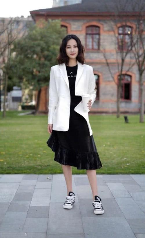 路人街拍美女白色的西装搭配黑色的裙子满满的女人味尽情绽放