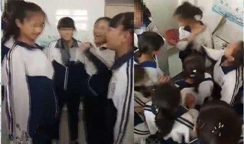 视频中多位身穿校服的女生在一片起哄声中对一位女同学掌掴.