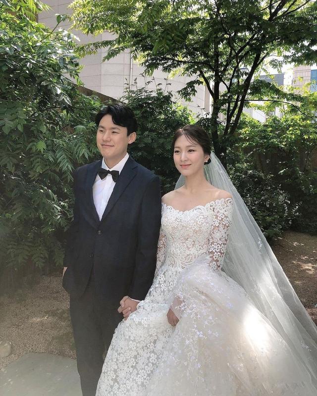 袭白色碎花婚纱,飘逸的头纱和婚纱交织在一起,整体简洁大方,美艳动人