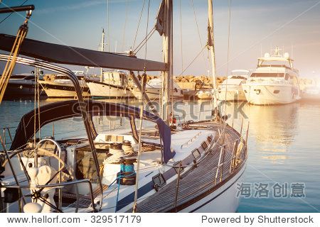 yacht in a berth on blue sea and blue sky background