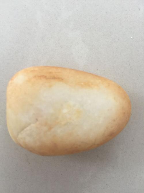 捡到一块米黄石头,打灯透明,请问是玉石吗?