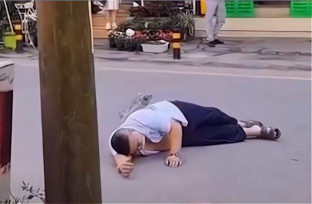 打滚耍赖中,男子把鞋都给踢掉了.