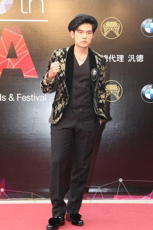 周杰伦穿著欧风古典风格的黑金西装,搭配黑色圆帽,霸气中又带点俏皮
