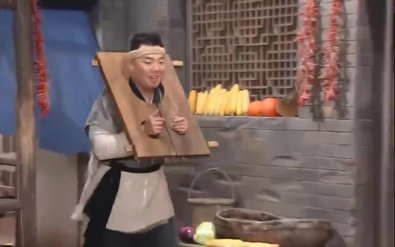 李大嘴戴着枷锁想让白展堂给他开锁白展堂却不帮他