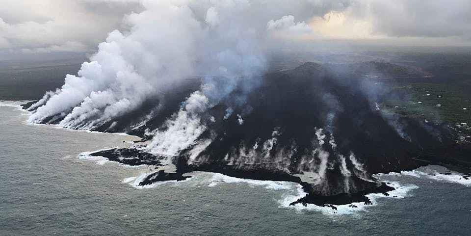 lava from kilauea flowing into the ocean at kapoho bay.