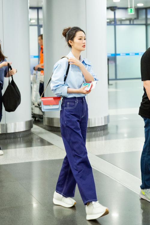 李沁现身长沙机场,浅绿色短上衣露出马甲线,造型时尚清爽