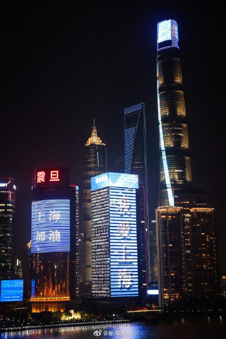 上海陆家嘴楼宇群亮灯,上面写着:"我爱上海","上海加油"