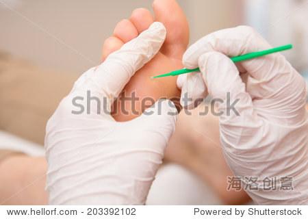 podiatrist ( chiropodist ) cleaning womans feet
