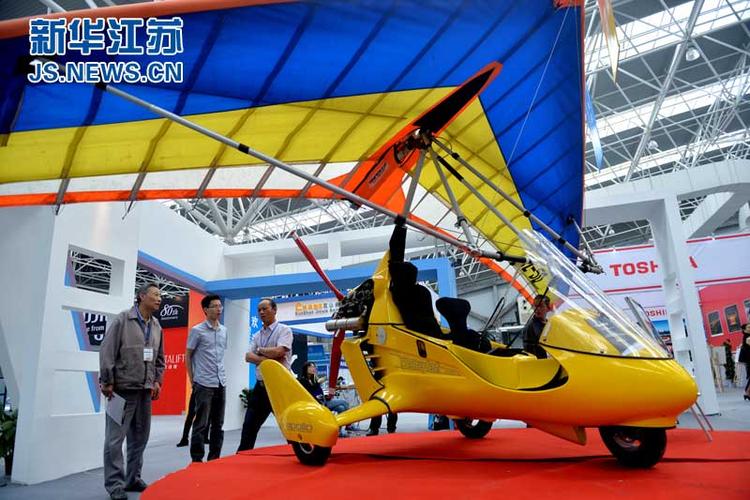 观众在交易会上参观展出的动力三角翼飞机.