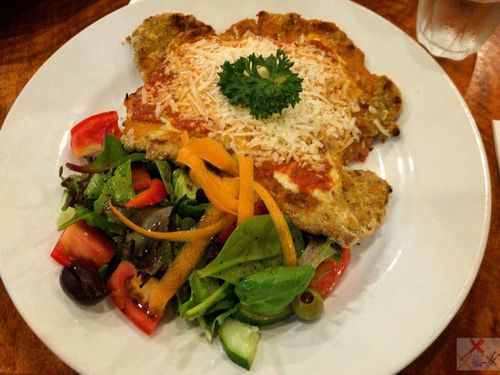 crumbed veal parmigiana at bel paese trattoria pizzeria, cairns