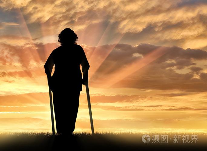 一位老太太拄着拐杖在户外的剪影