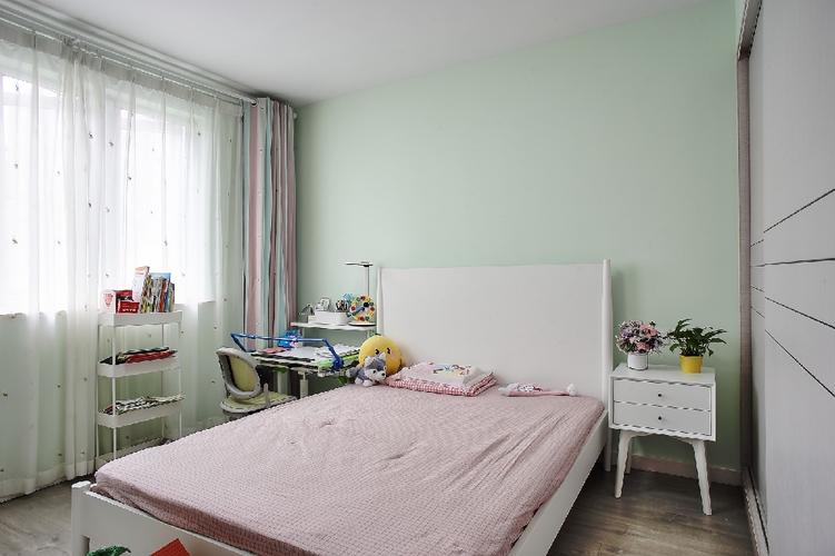 儿童房墙面刷浅绿色,简洁白色的衣柜和木床,彩虹般的窗帘和纱帘,营造