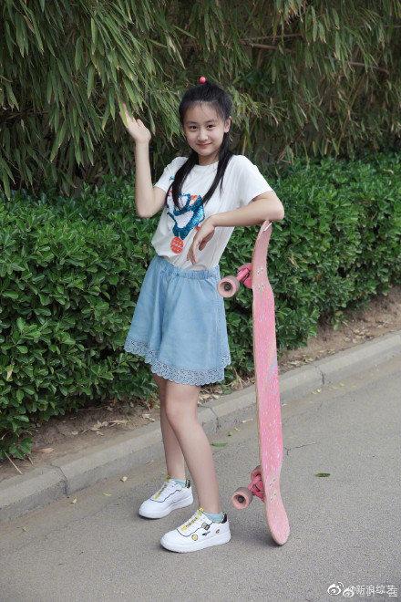 分享女儿田雨橙近照,照片中的森碟长发飘飘,身着白t和