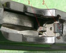 图中1为抛壳挺,2为拉壳钩