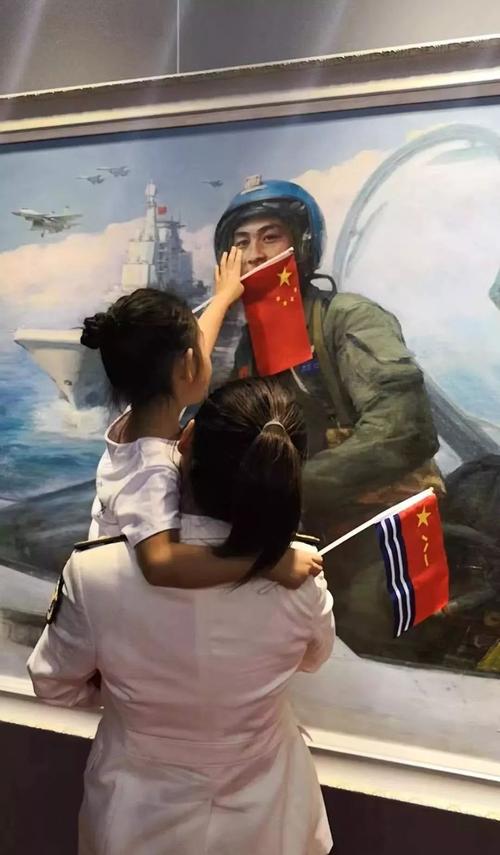 张超的妻子和女儿在张超的画像前