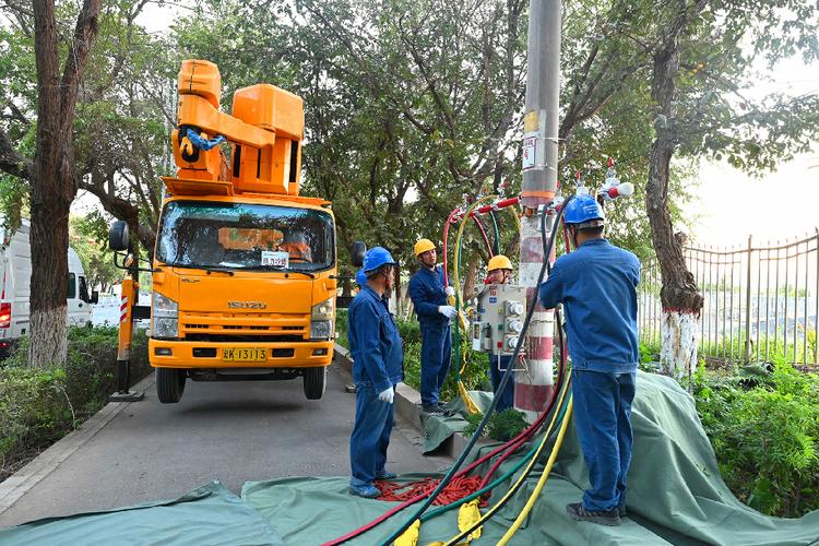 9月9日,国网吐鲁番供电公司带电作业人员正在接入旁路电缆.