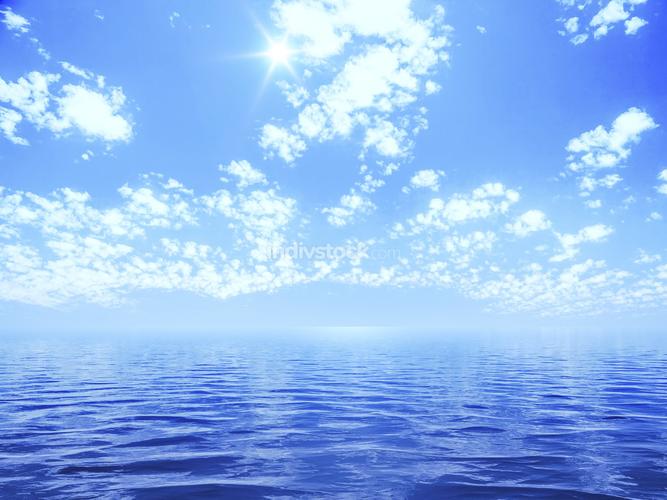 blue sky with some clouds and the sun over the ocean