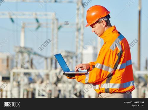 engineer builder with laptop computer at construction site near