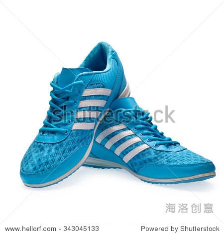 a pair of blue sports shoes with shoelace on a white background