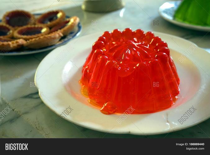 bright red jelly or jello with tarts and green jelly in the back