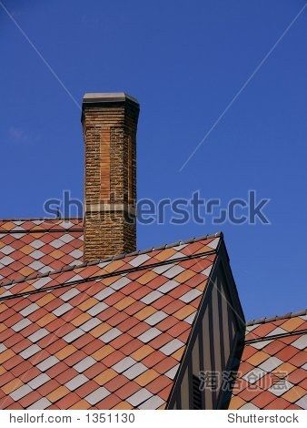 and red tile shingles on the roof of a building with chimney on