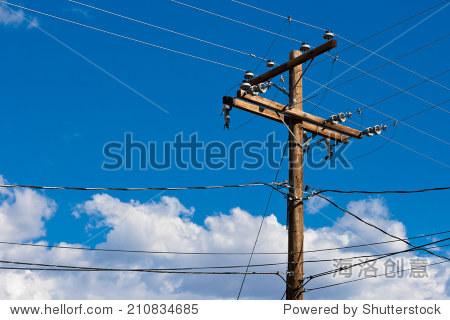 wooden pole with wires against the blue sky