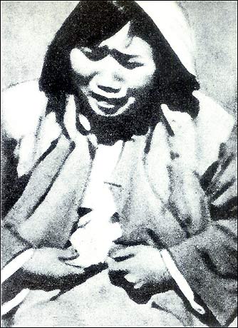 raping this old woman, japanese troops force her to disrobe