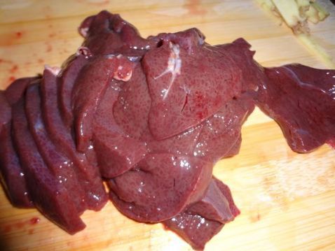 猪肝洗净切片备用 大蒜斜切长条备用 起锅热油爆香姜丝 炒至猪肝变色