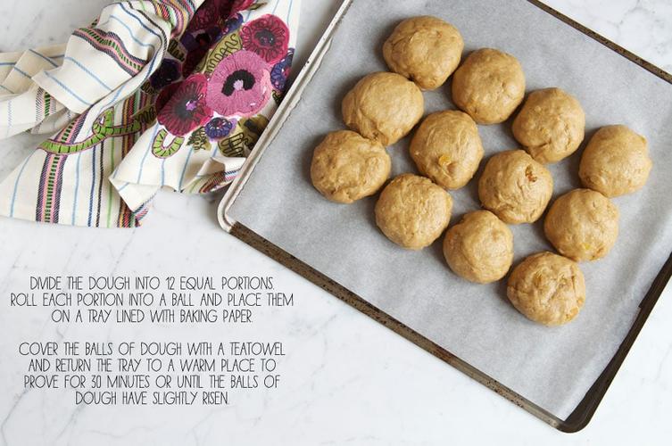 hot cross bun dough rolled into twelve portions on baking tray