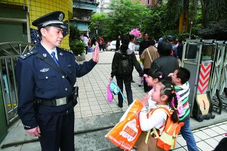 校警在幼儿园大门前执勤 记者 吴珊 摄