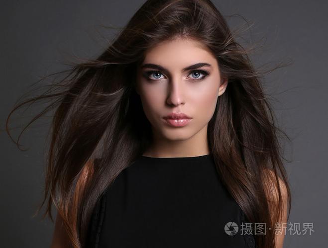 黑直头发的华丽性感女人穿着优雅的衣服