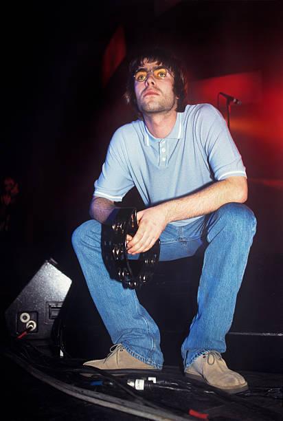 liam gallagher performing with oasis at the paramount theater in