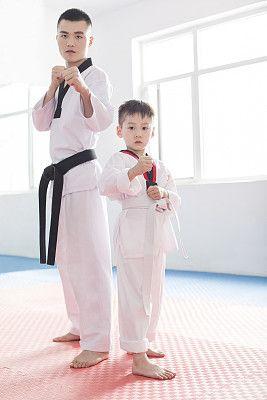 年轻教练教小男孩跆拳道