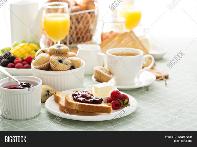 fresh and bright continental breakfast table with jam on toast
