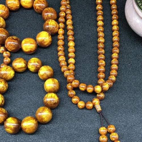 产低货源金丝海柳佛珠手串粉压金丝海柳琥珀佛珠饰品手链批发