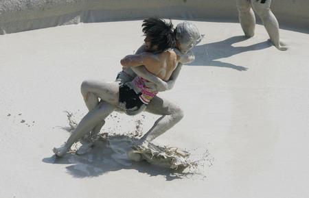 mud and guts in women"s mud wrestling contest