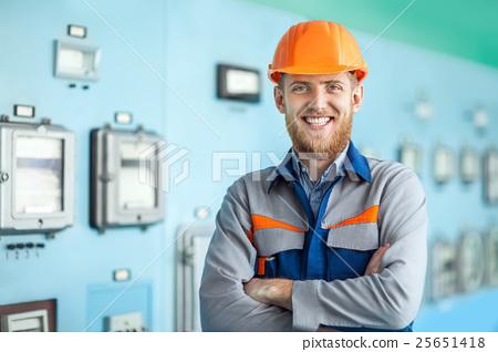 图库照片: portrait of young happy engineer at control room