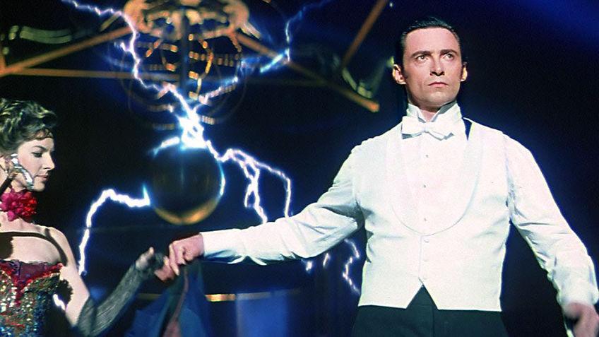 two stage magicians engage in competitive one-upmanship in an