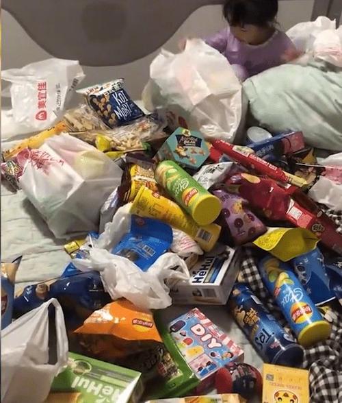 爸爸醉酒后给女儿买零食,铺满一张床,女儿面对零食堆不知所措