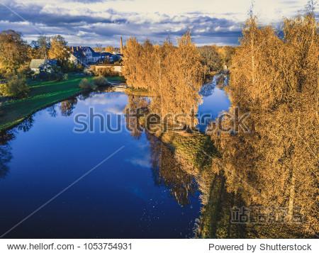 aerial photo of a lake in sunny autumn day with a view over the