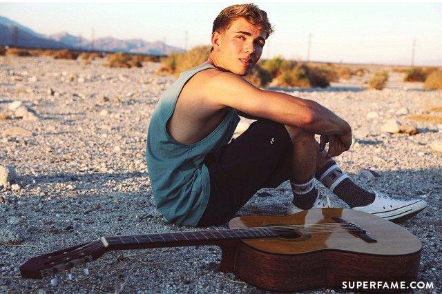 jake sits alone with his guitar. (photo: instagram)
