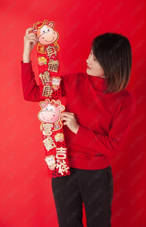 摄影图 照片 人物情感 > 美女新年手持富贵吉祥身体健康对联拜年高清
